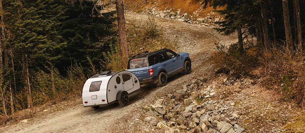 2026 Ford Bronco Sport® being driven with a trailer being towed behind it