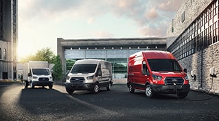 Ford E-Transit™ models parked in front of an office building