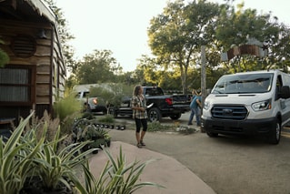 Woman looking at a Ford Transit outdoors