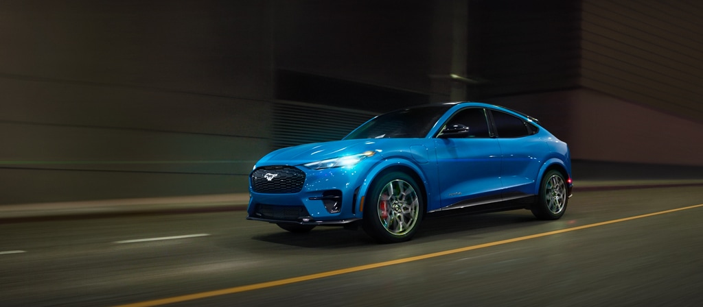 2026 Ford Mustang Mach-E® GT model being driven on a city street