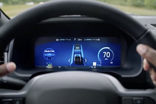 The BlueCruise screen shown behind a steering wheel