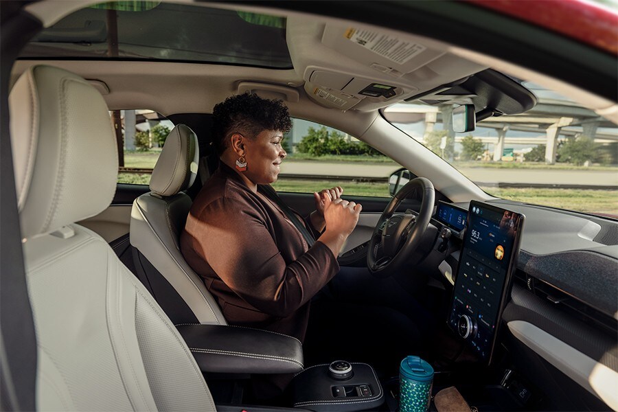 A 2022 Ford Mustang Mach-E® being driven by a person with BlueCruise on a center stack