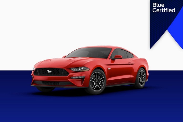Ford Mustang next to a Blue Certified banner