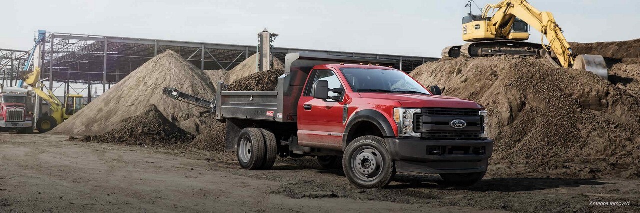 Ford [Vehicle model or type] parked in a construction site with heavy equipment operating in the background
