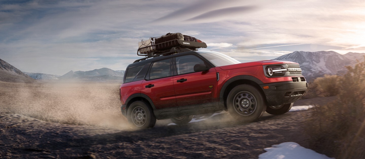 2021 Ford Bronco in Rapid Red being driven over rocky terrain