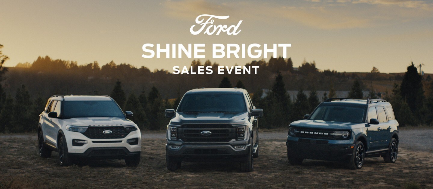 2023 Ford Explorer, 2023 Ford F-150 and a 2023 Ford Bronco lined up with Christmas trees in the background