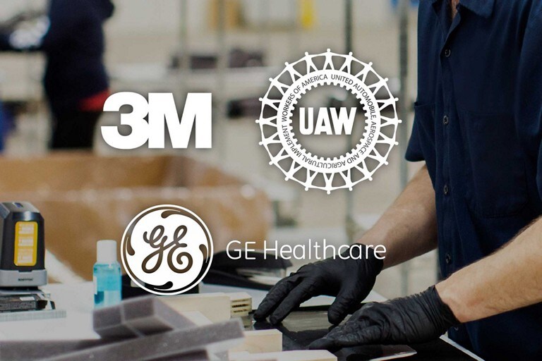 The 3 M, G E and U A W logos overlay an image of persons gloves hands