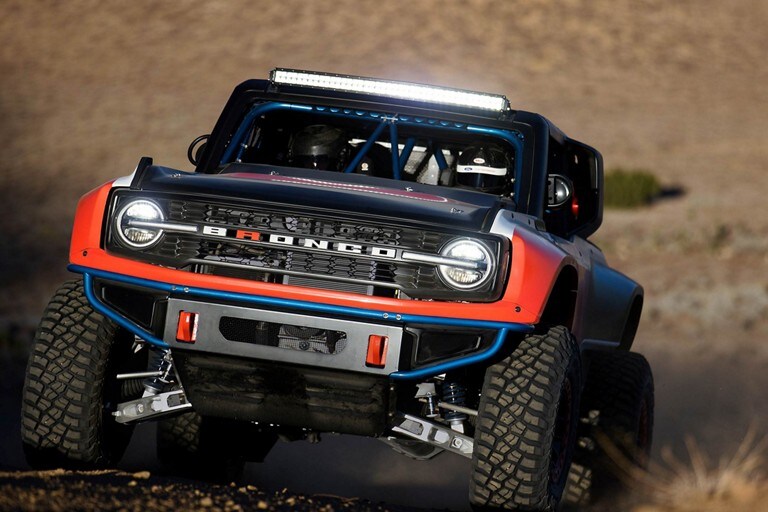 Front shot of bronco d r being driven in the desert