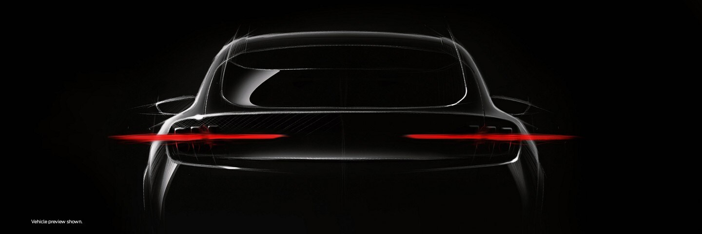 The mustang-inspired, fully electric performance utility vehicle in a sleek black setting shown from the rear with glare coming from the tail lamps