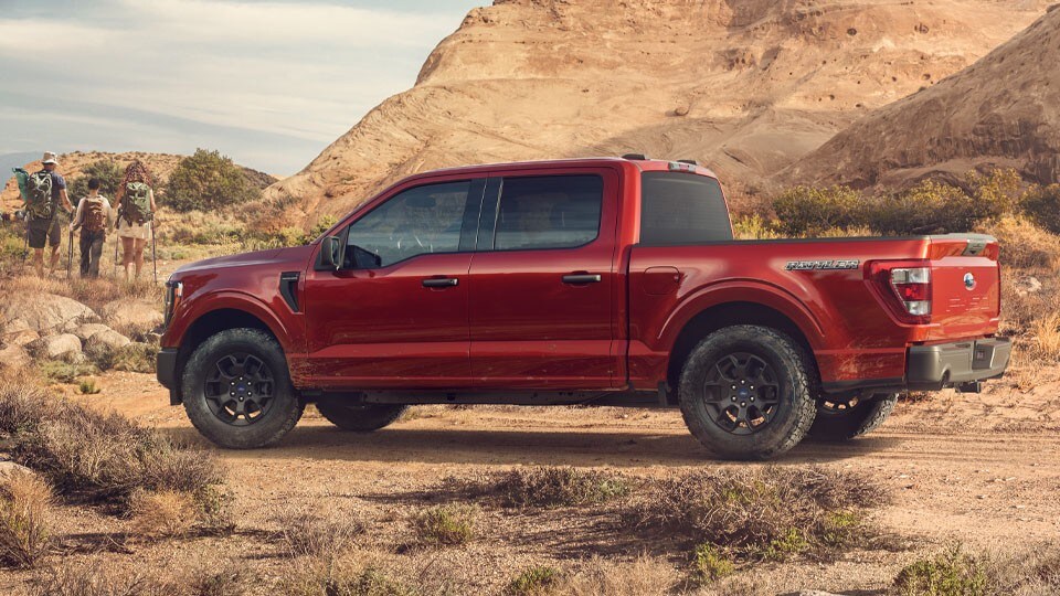 2023 Ford F-150® Rattler™ in Red sitting in a rocky mountain area