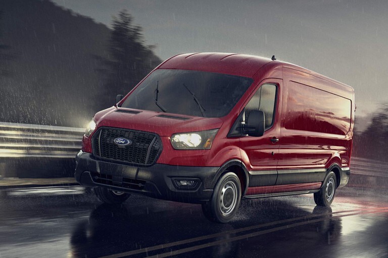 A 2022 Ford Transit being driven on a wet road