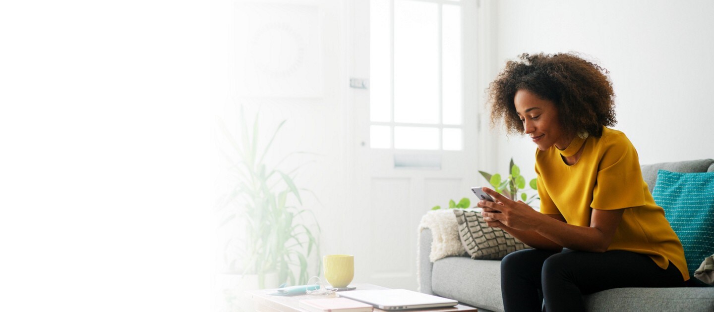 Young woman shopping for a new Ford vehicle online on her phone while at home