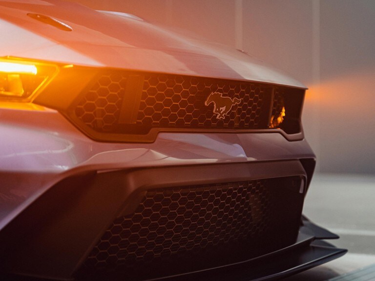 Front grille of a 2025 Mustang® GTD with running headlamps on