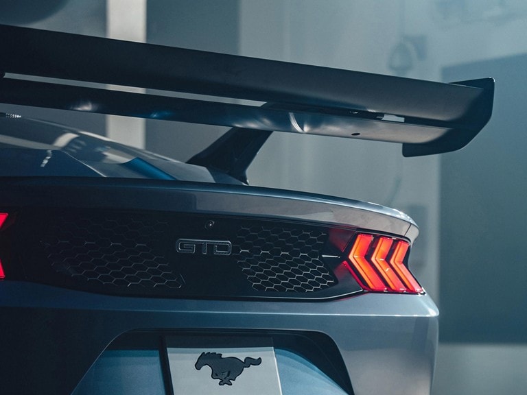 Rear view of a parked 2025 Mustang® GTD with available active aero rear wing