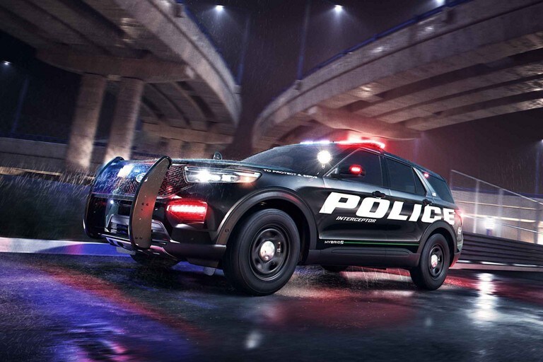 The ford police interceptor utility passing under a city bridge