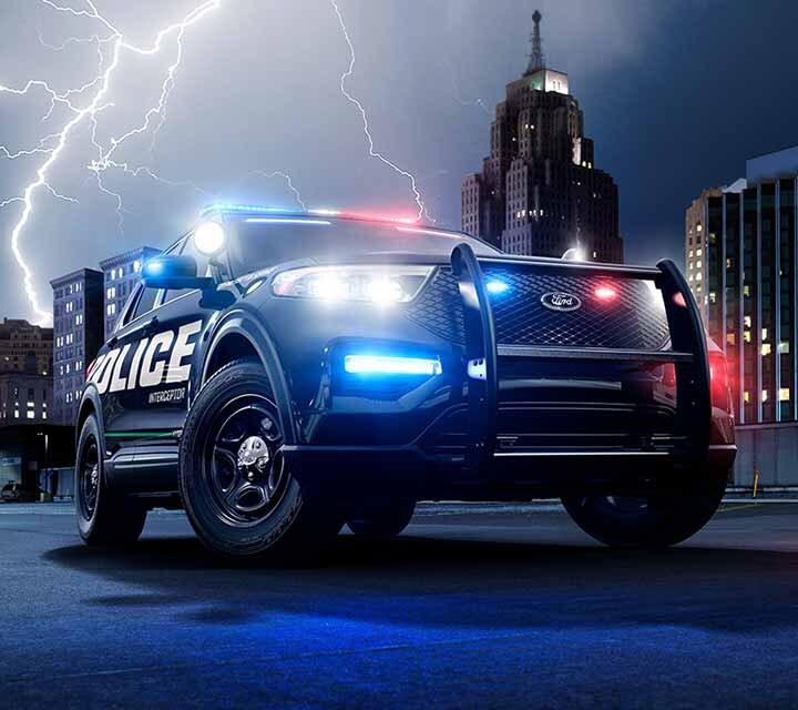 The ford police interceptor utility seen against a city skyline