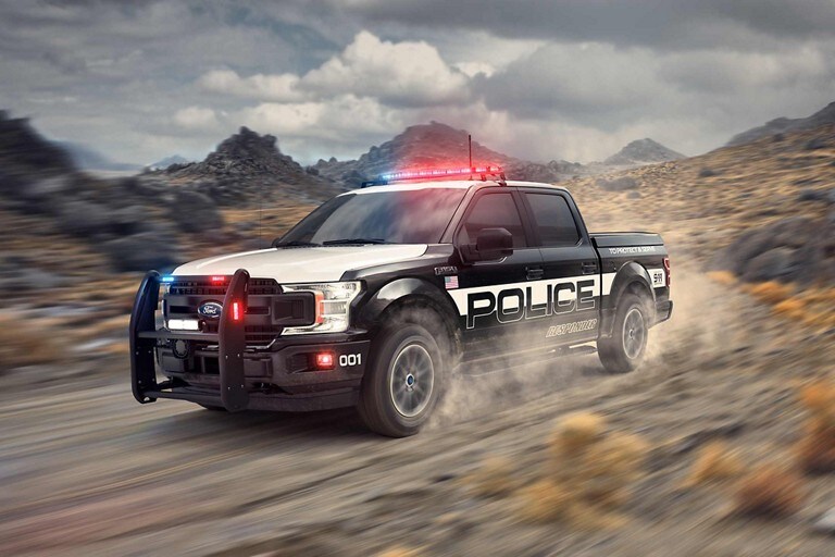 The f one fifty police responder drives along a country road