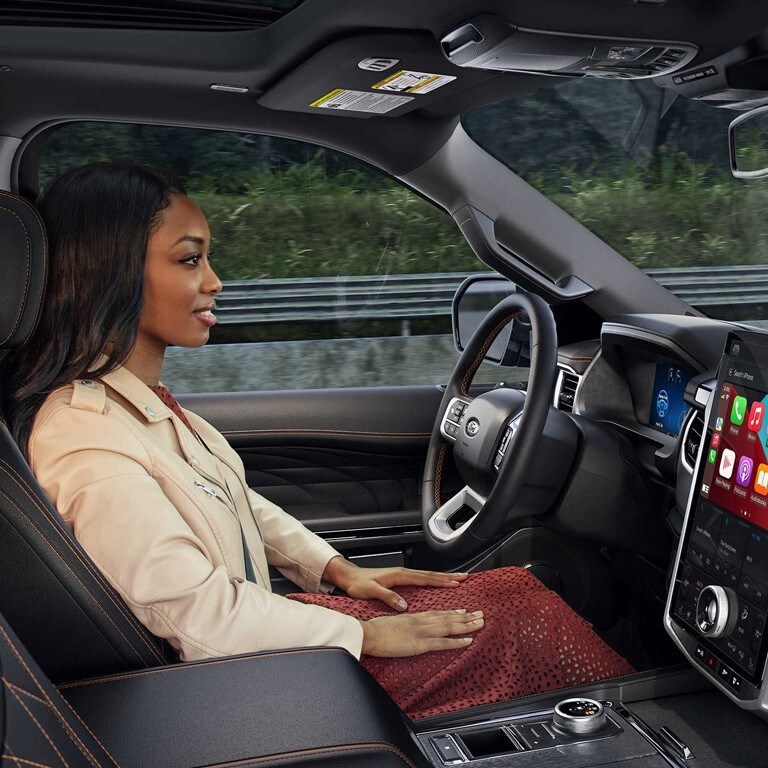 A person driving a Ford SUV.