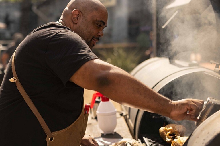 A man is cooking on a grill