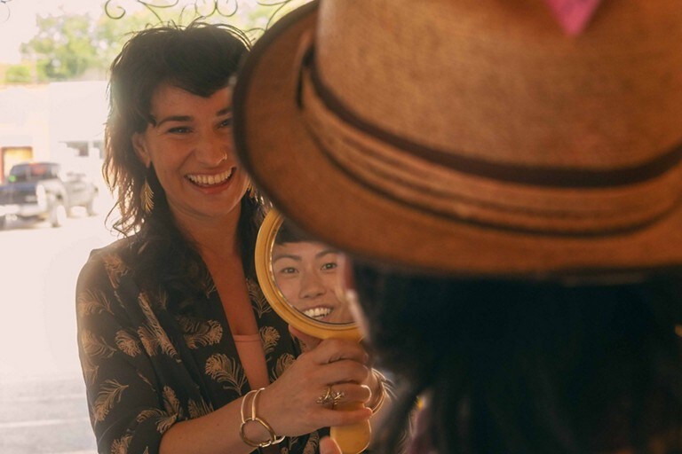 A woman looking at her reflection in a mirror