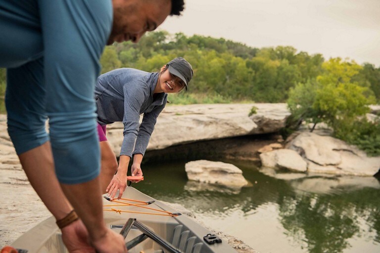 Two people getting a canoe ready for using