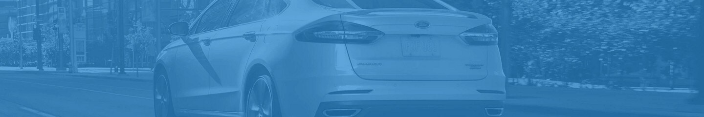 Back end of 2020 Ford® Fusion shown on a blue background