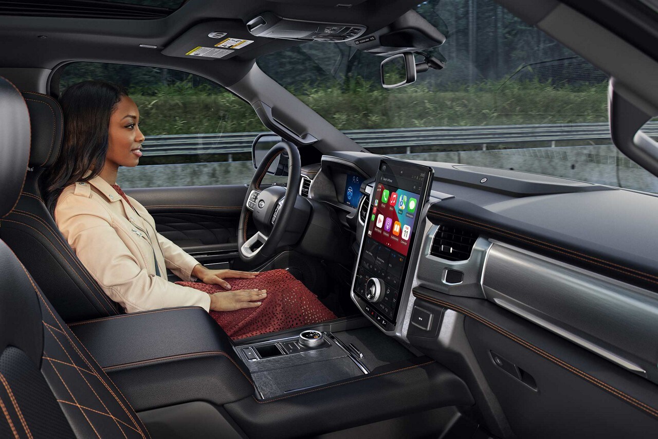 A woman driving her 2023 Expedition hands-free down a highway