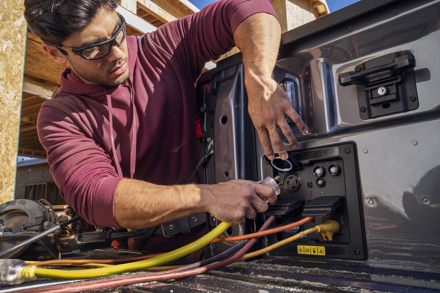 Close-up of a power cord being plugged into an outlet of a 2022 F-150 Lightning.