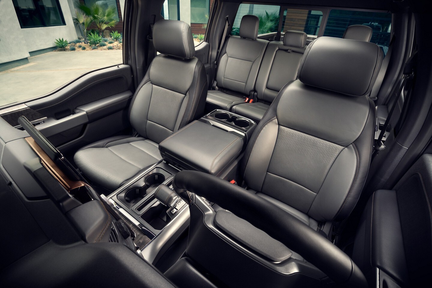 Interior of a 2022 F-150 Lightning showing its center console and spacious seating.