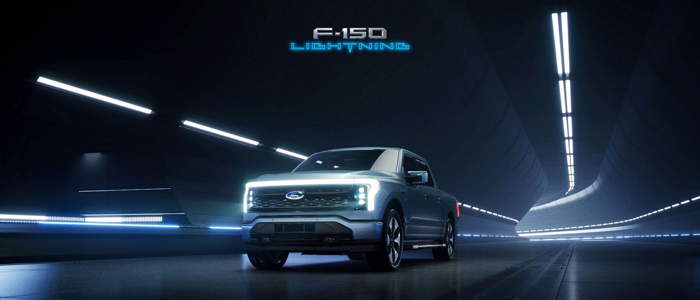 Iced Blue Silver 2022 F-150 Lightning driving through a tunnel at night.