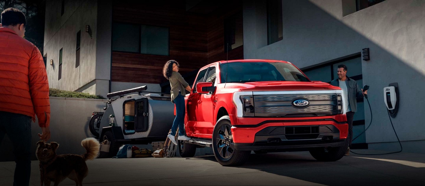2023 Ford F-150® Lightning™ charging in a home driveway