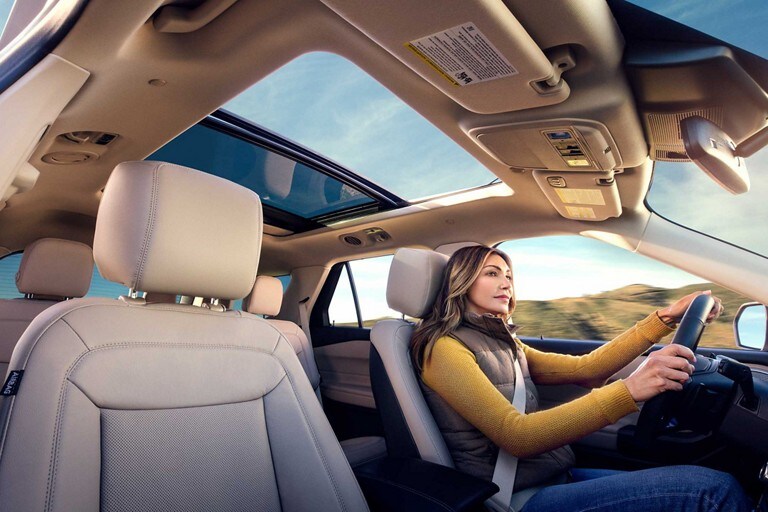 A woman driving a 2020 Ford Explorer