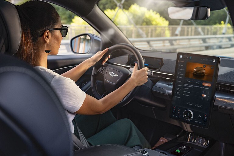 A woman driving her Mustang Mach-E