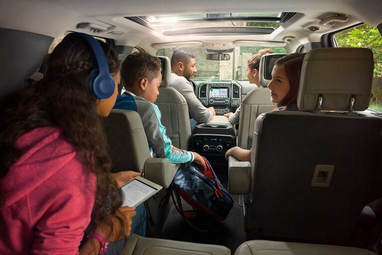 A family using the in vehicle wi fi hotspot in a 2020 Ford Expedition