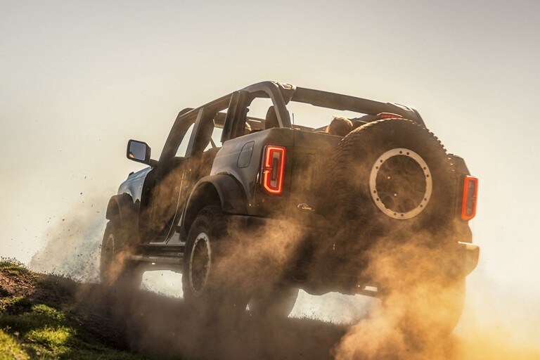 A 2023 Ford Bronco® model being driven over a rough trail