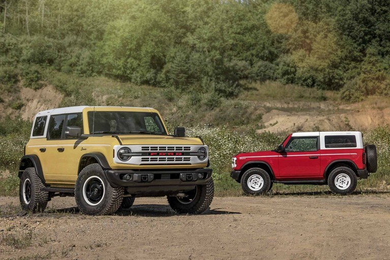 Two 2023 Ford Bronco® Heritage Editions parked in a clearing