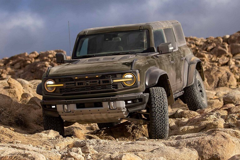 2024 Ford Bronco® in Shelter Green driving down rocky terrain