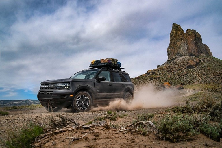 2023 Ford Bronco® Sport model being driven with a rocky cliff in the background