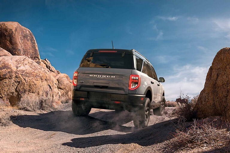 Shown is the back of the 2024 Ford Bronco® Sport SUV being driven over rocky terrain