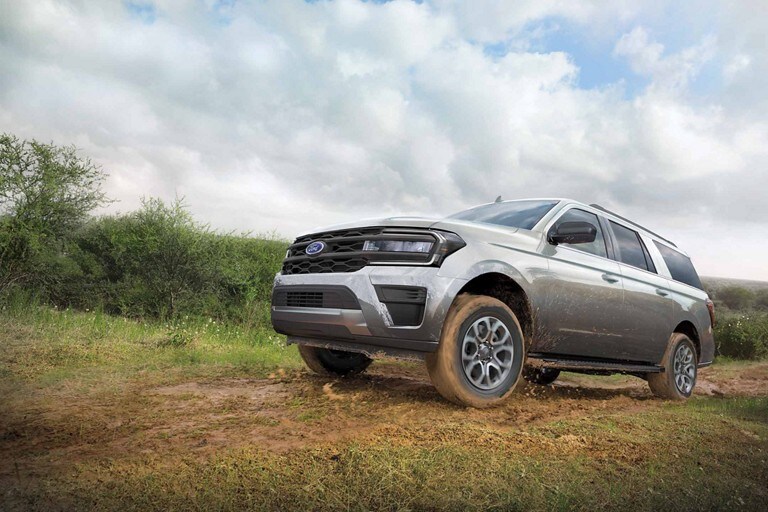 18-inch wheels shown on a 2024 Ford Expedition XL STX being driven on a muddy road