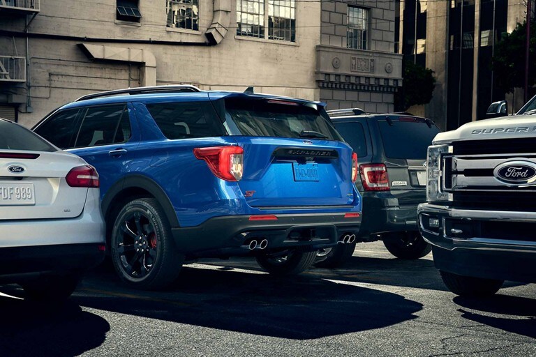 2023 Ford Explorer® SUV parked with rear parking sensors being activated as a truck passes behind it