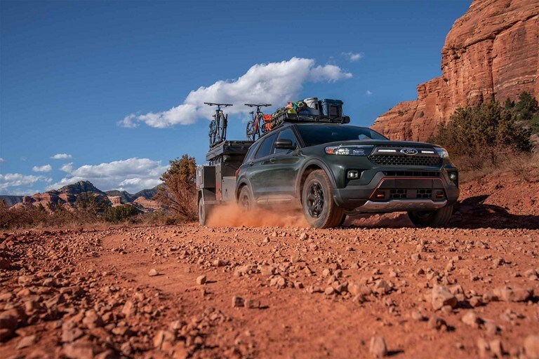 2023 Ford Explorer® Timberline® model being driven in the desert while towing a trailer
