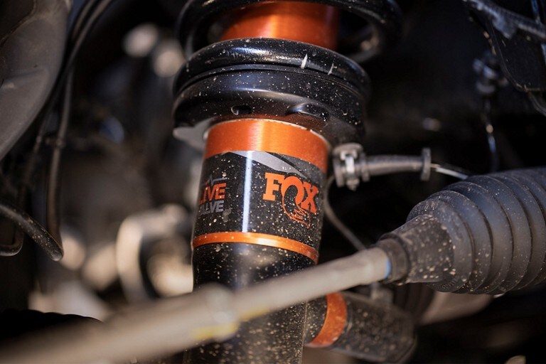 Close-up of FOX™ Live Valve™ shocks installed on the 2023 Ford F-150 Raptor®