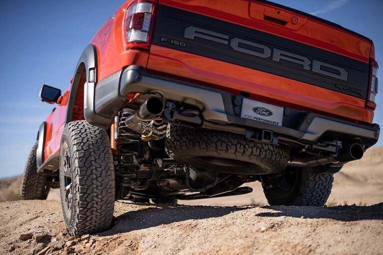 Close-up of rear suspension as 2023 Ford F-150® Raptor® is driven over rough terrain