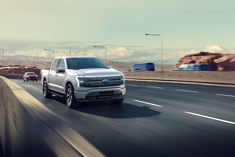 A 2023 Ford F-150 Lightning® being driven on a highway