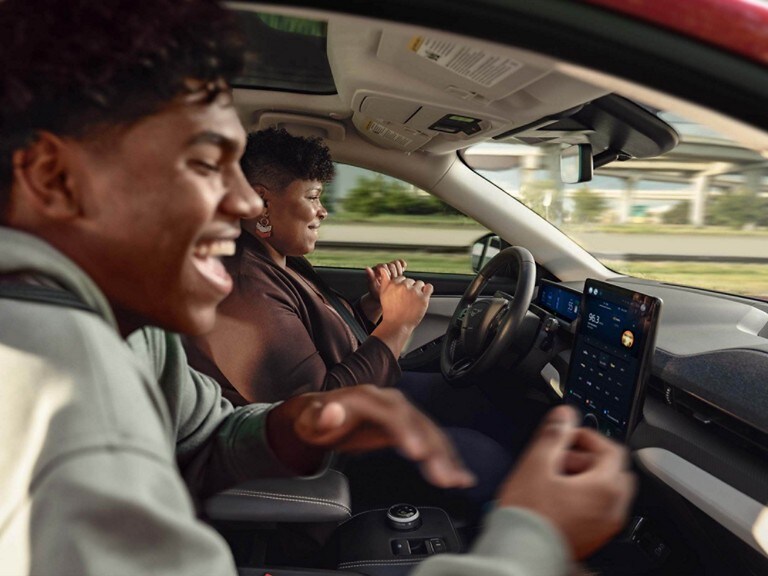 Driver and passenger enjoying the BlueCruise feature