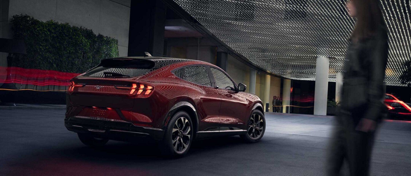 Red 2023 Ford Mustang Mach-E With headlights on in dark