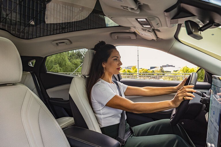 Interior view of a woman driving a 2023 Ford Mustang Mach-E® SUV