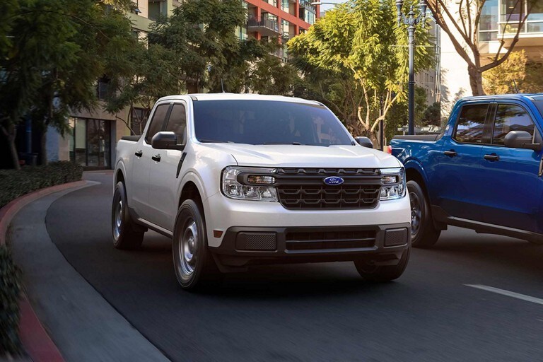 2024 Ford Maverick® XL truck in Oxford White being driven down the street