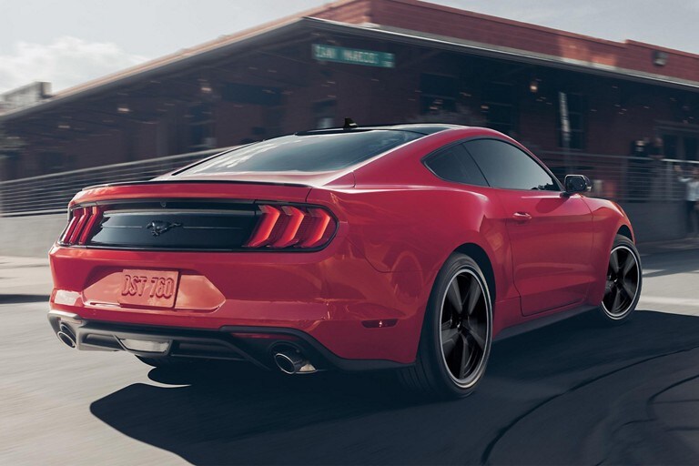 A 2023 Ford Mustang® coupe being driven on a street